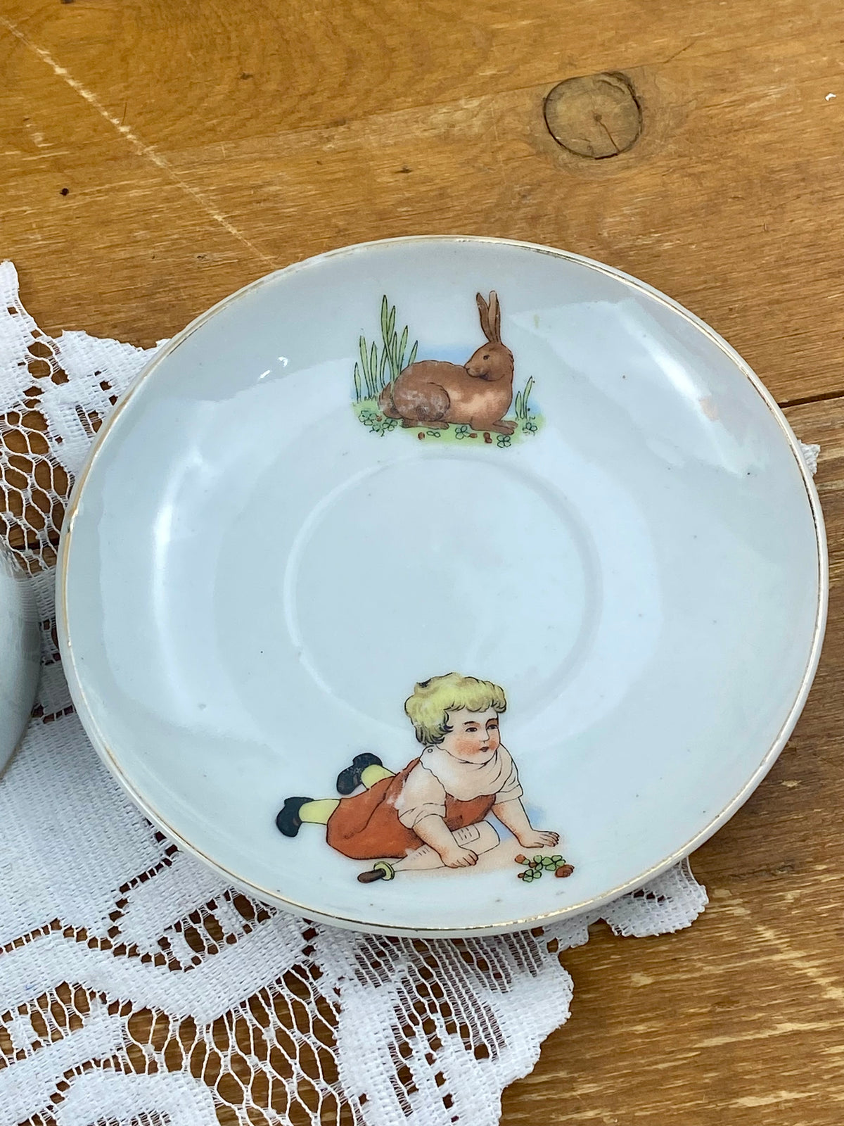 Delicate Hand Painted Child’s Teacup and Saucer Set Featuring Child and Bunny