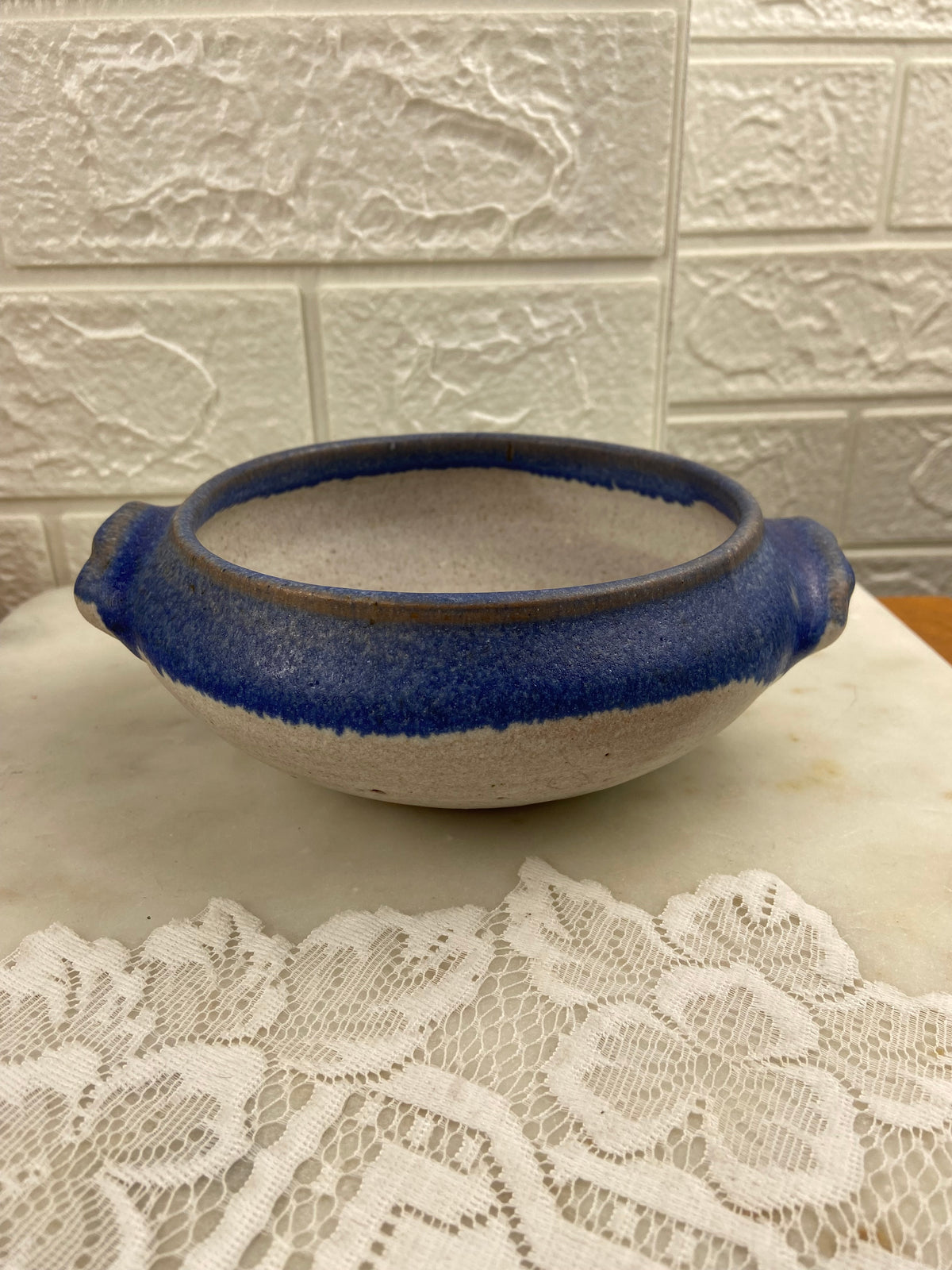 Handcrafted Speckled Pottery Bowl with Blue Rim and Double Handles
