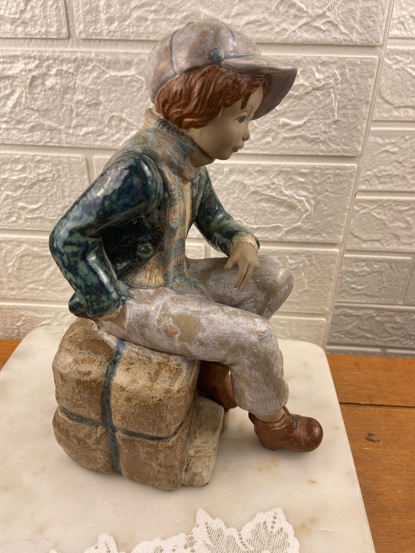Porcelain Figurine | Boy Sitting on Cargo by Porcelana Artistica Levantina (PAL)