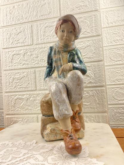 Porcelain Figurine | Boy Sitting on Cargo by Porcelana Artistica Levantina (PAL)